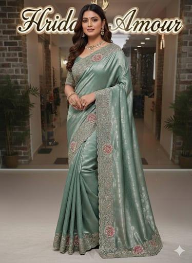 Model in a sage embroidered saree with ornate floral border